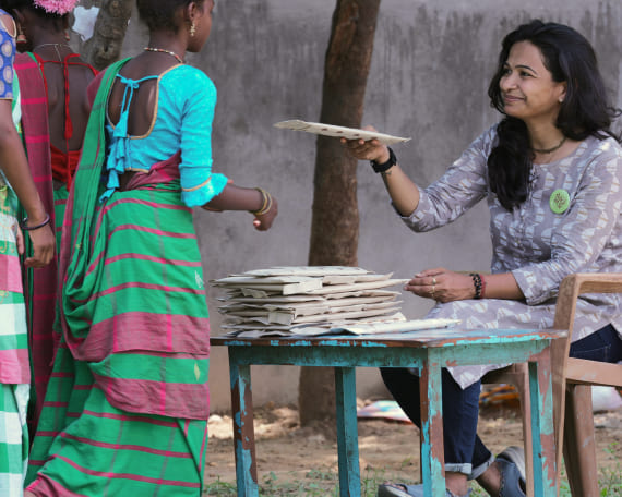 Woman sharing sanitary pads to child